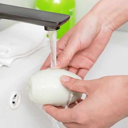 Rinsing the reusable lint roller under running water to clean off collected lint
